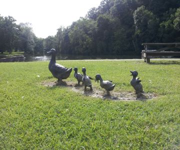 Statues of ducks on grass